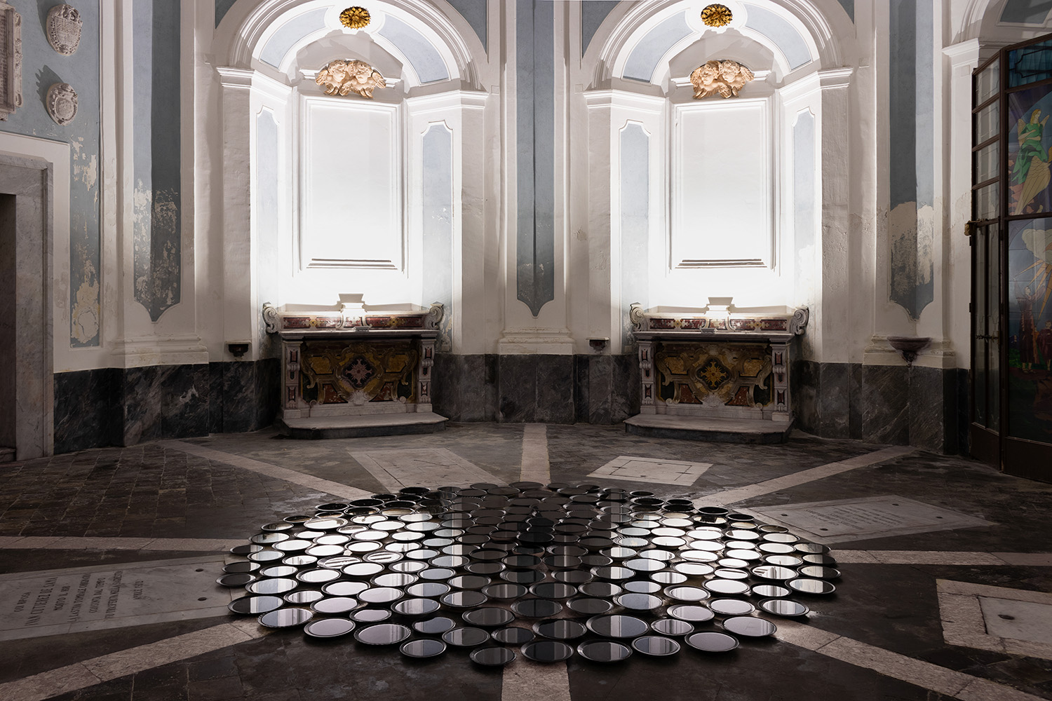 the reflection in the water inside black plates shows a baroque church