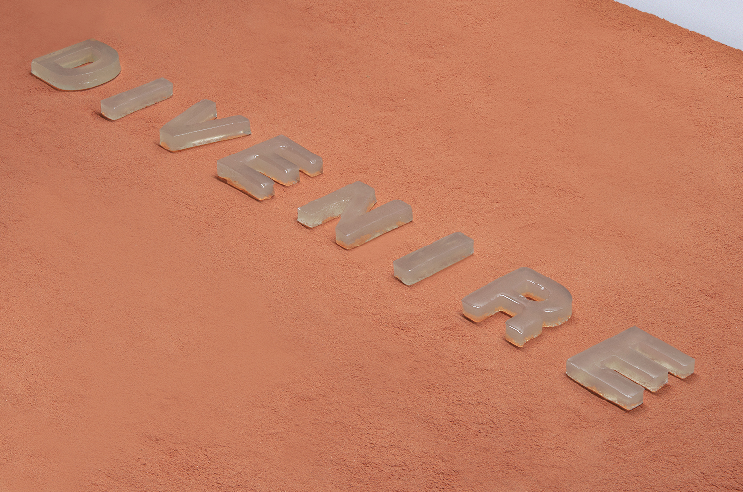 A site-specific installation with letters made with agar on top of red molding sand