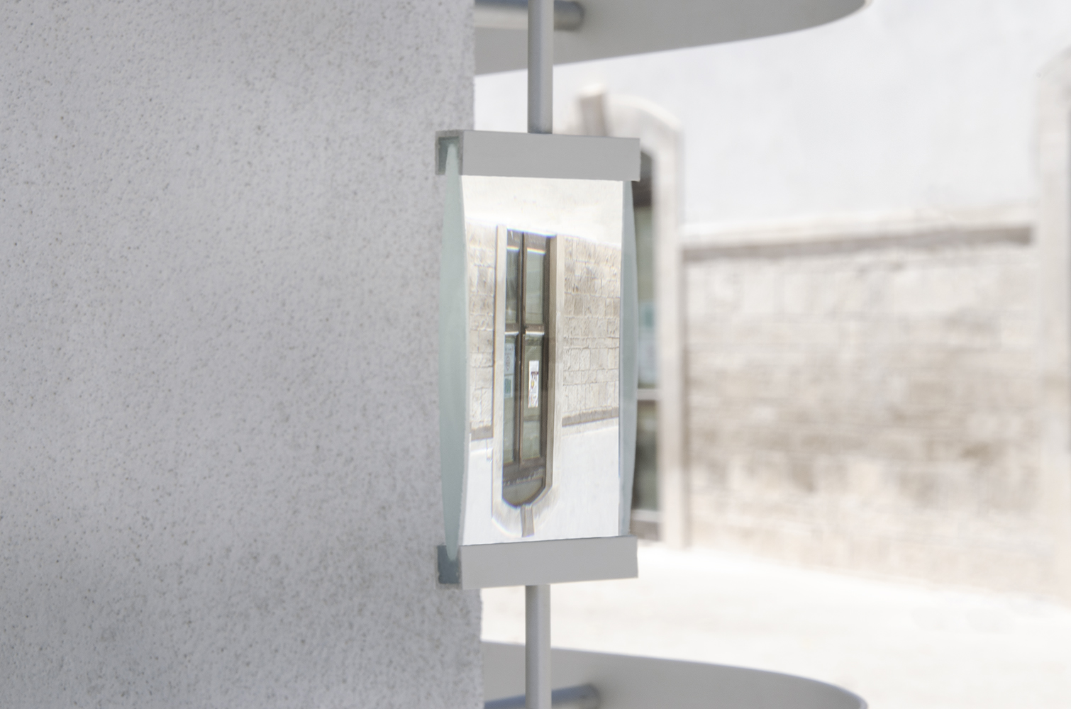 A site-specific installation with a magnifying glass that shows a flipped door